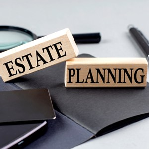 Wooden blocks and pen on the table, symbolizing estate planning concept